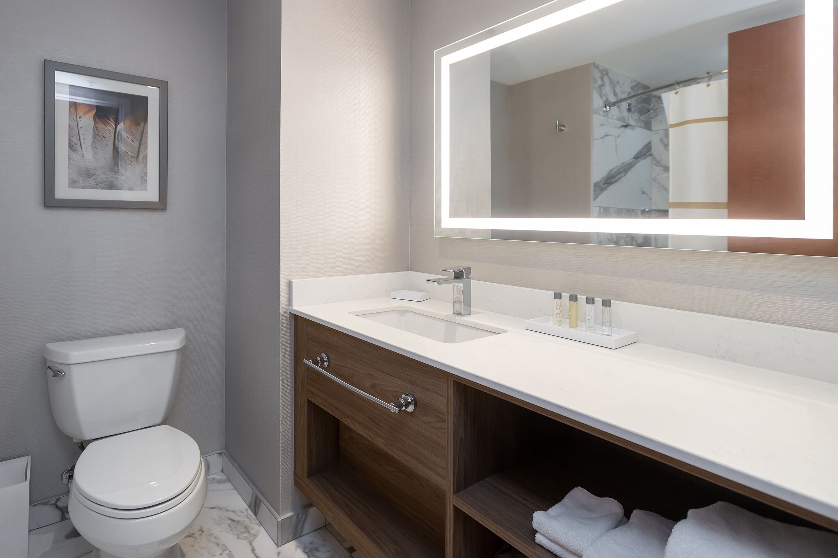 combined shower/bathtub, designer toiletries, hair dryer, towels