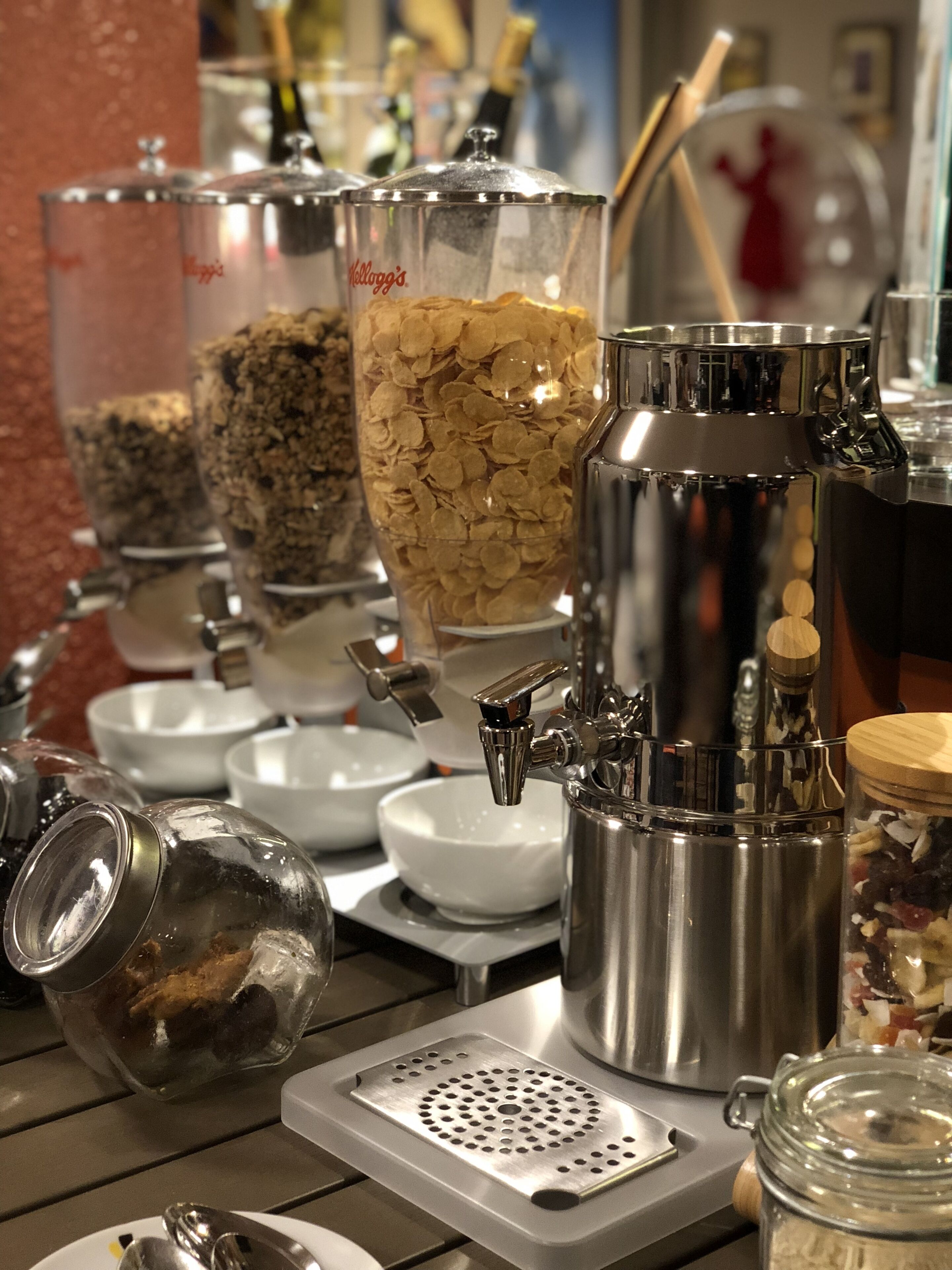 A buffet setup with various food containers and utensils.