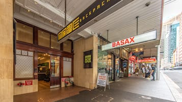 A storefront with a sign for 'Basax' and a 'Maze Backpacks' sign indicating it's open.