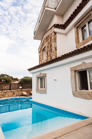 A two-story building with a swimming pool, stone facade, and a balcony. - Dolce Vita Boutique Hotel (Arzachena)
