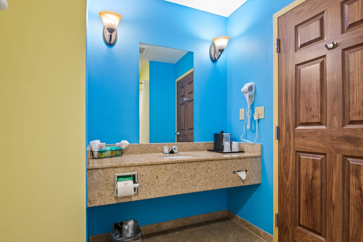 combined shower/bathtub, designer toiletries, hair dryer, towels