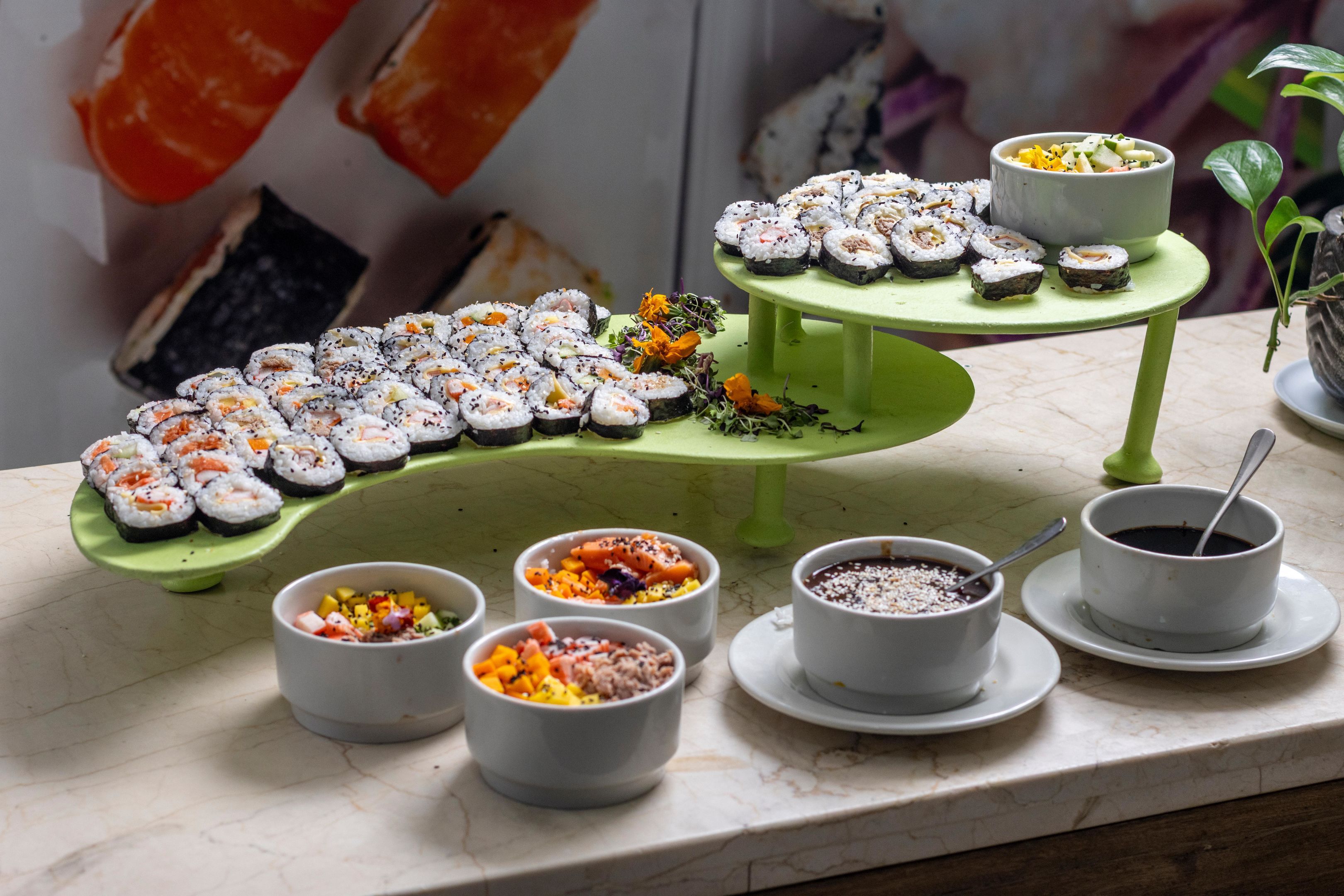 A variety of sushi and side dishes on a table.