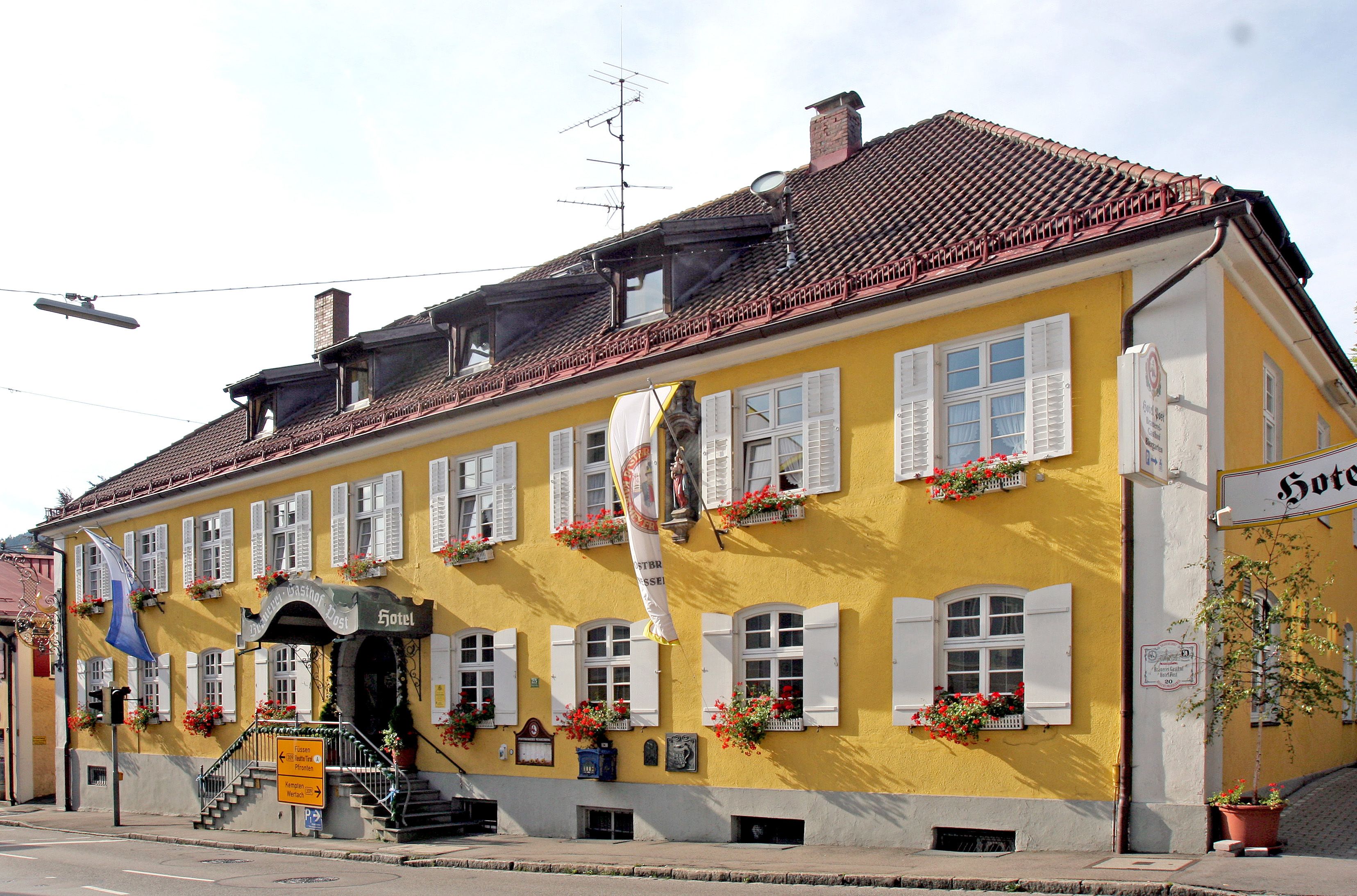 A yellow building with a sign reading "Hotel."