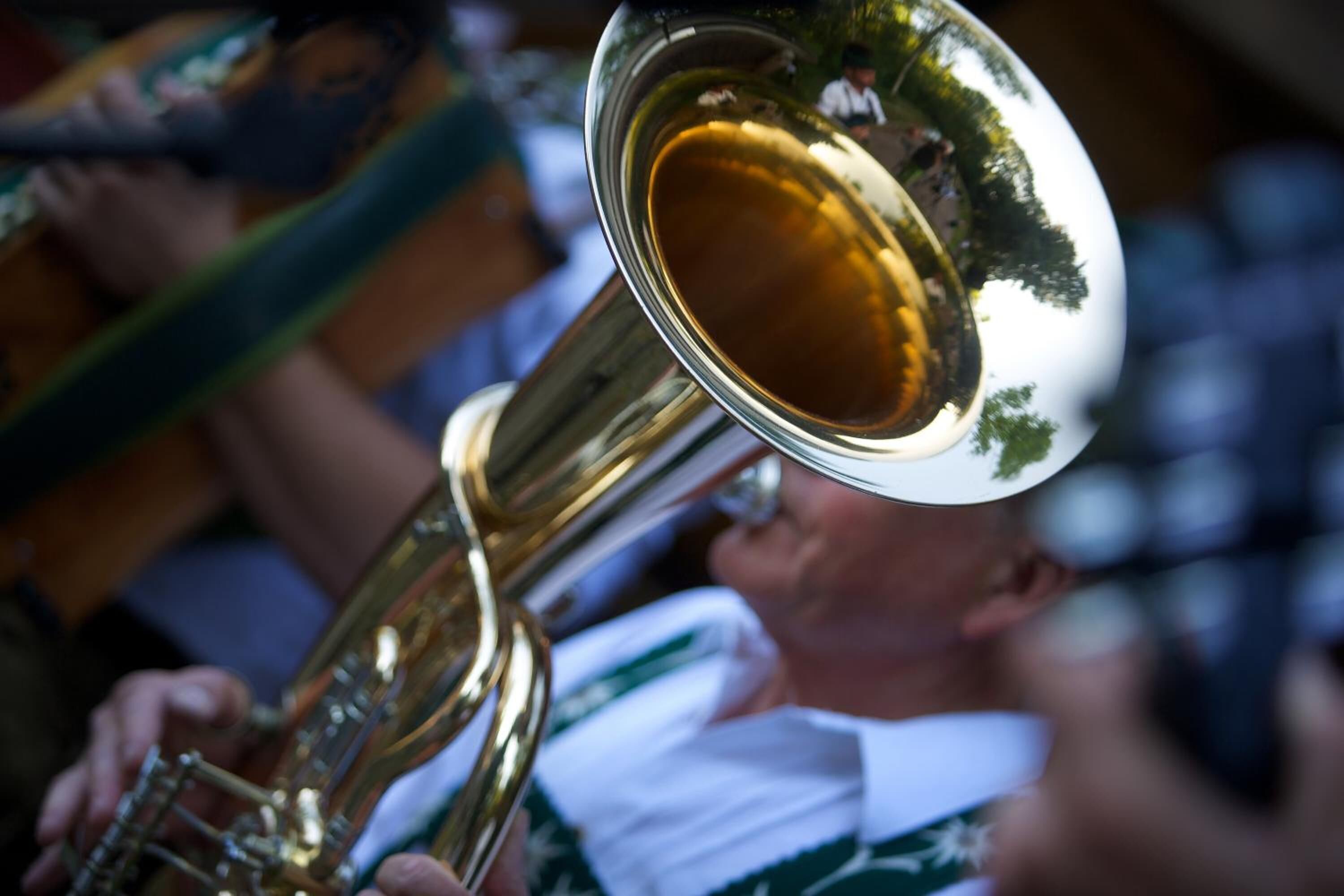 A brass musical instrument, likely a trombone, held by a person.