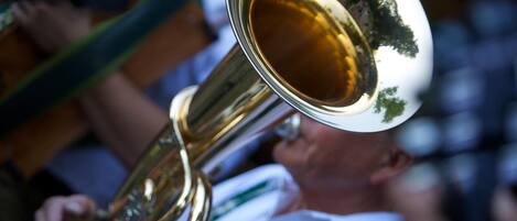 A brass musical instrument, likely a trombone, held by a person.