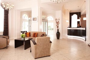 A spacious lobby with a reception desk, a sofa, and a coffee table. - New Continental Hotel, Sure Hotel Collection by Best Western (Plymouth)