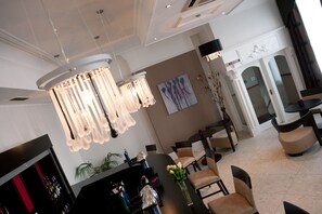 A modern hotel lobby with a chandelier, dining area, and a bar. - New Continental Hotel, Sure Hotel Collection by Best Western (Plymouth)