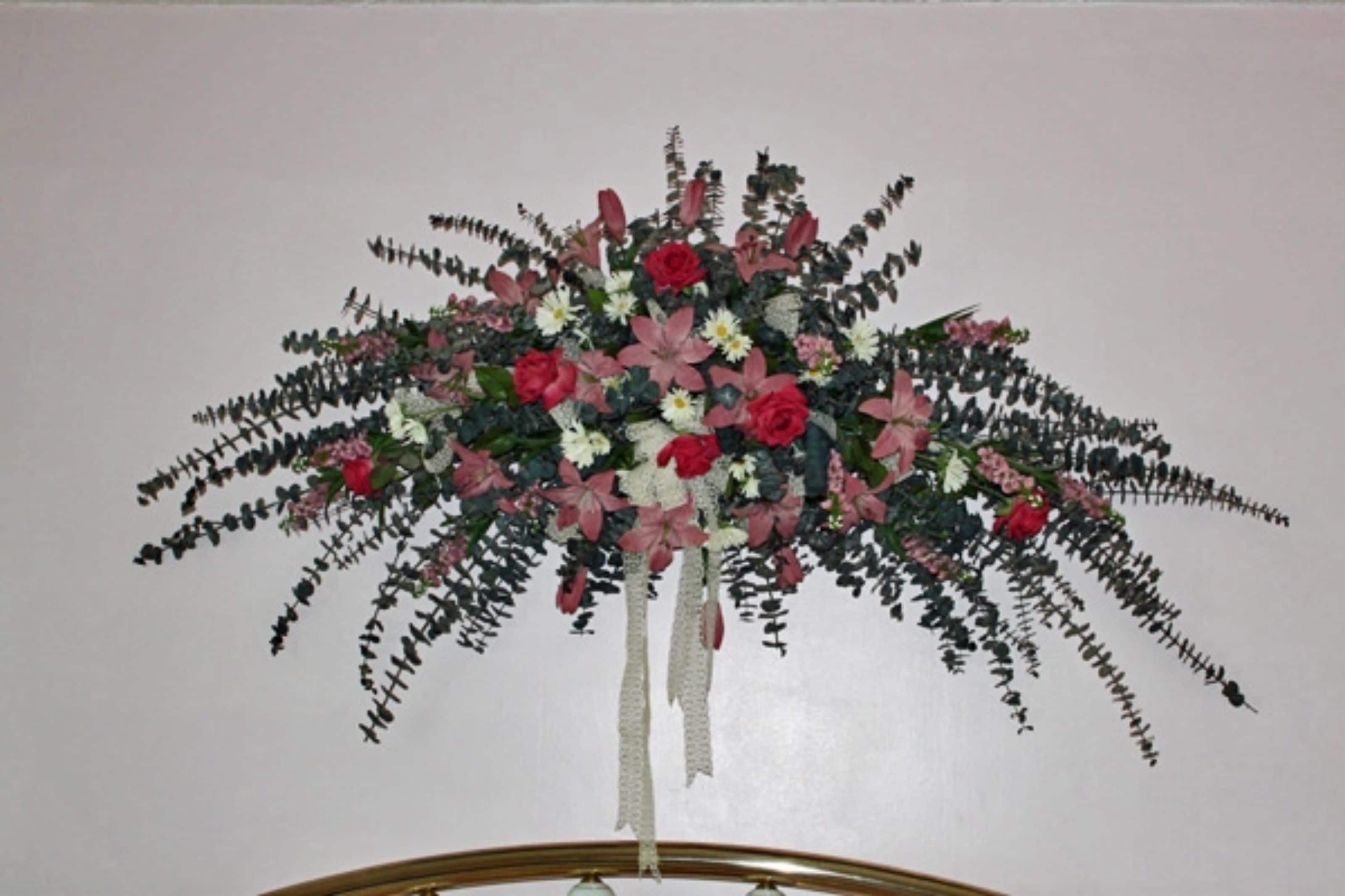 A floral arrangement on a stand.