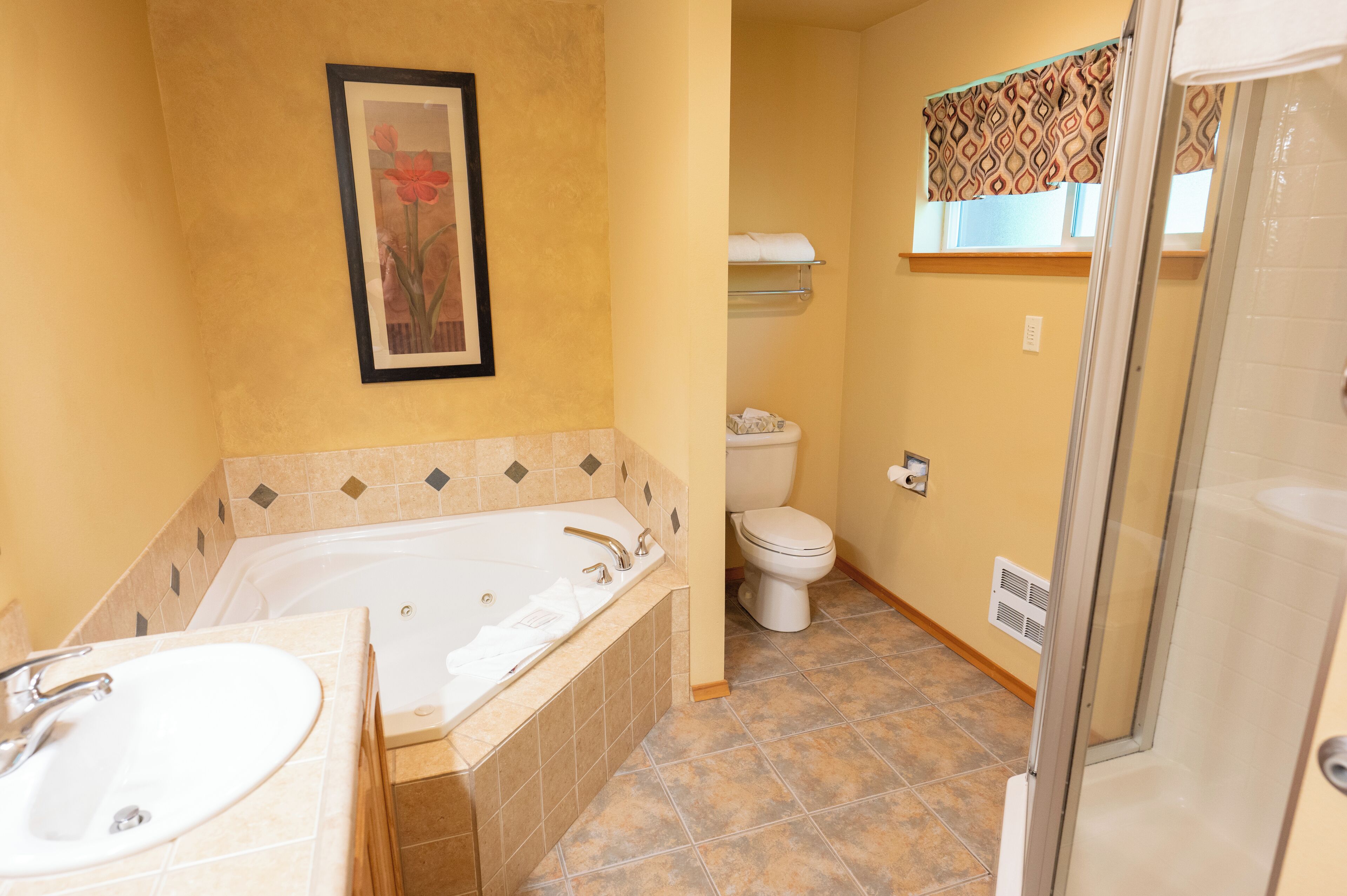 A bathroom with a bathtub, toilet, and sink.