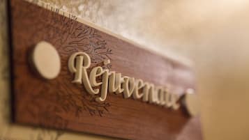 A wooden sign with the word "Rejovenace" carved into it.
