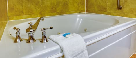 Una bañera con una toalla blanca y una barra de jabón.