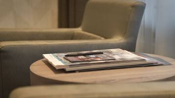 A seating area with a cushioned chair and a small wooden table.