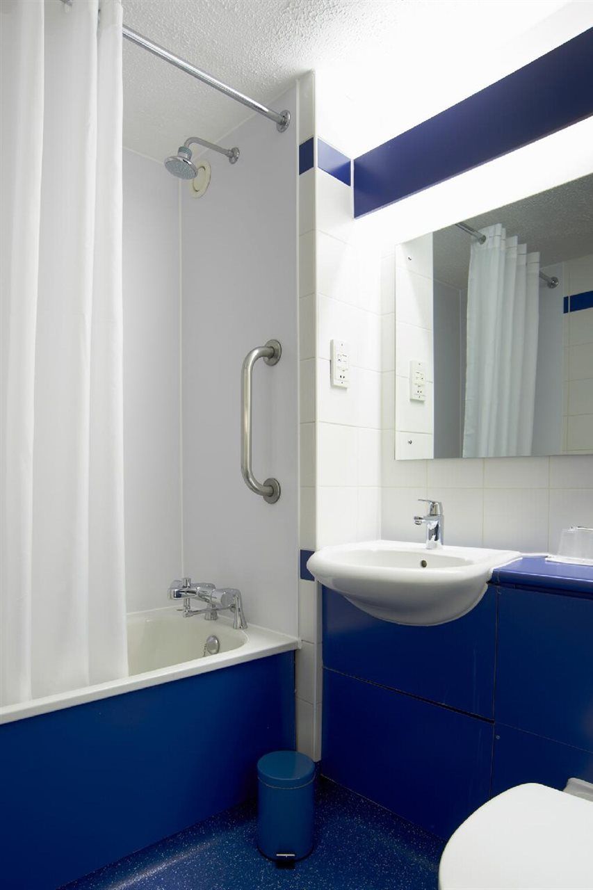 A bathroom with a bathtub, a sink, and a toilet.