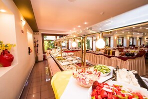A buffet setup with various food items and a clear view of the room layout. - Brascos (Rethymno)