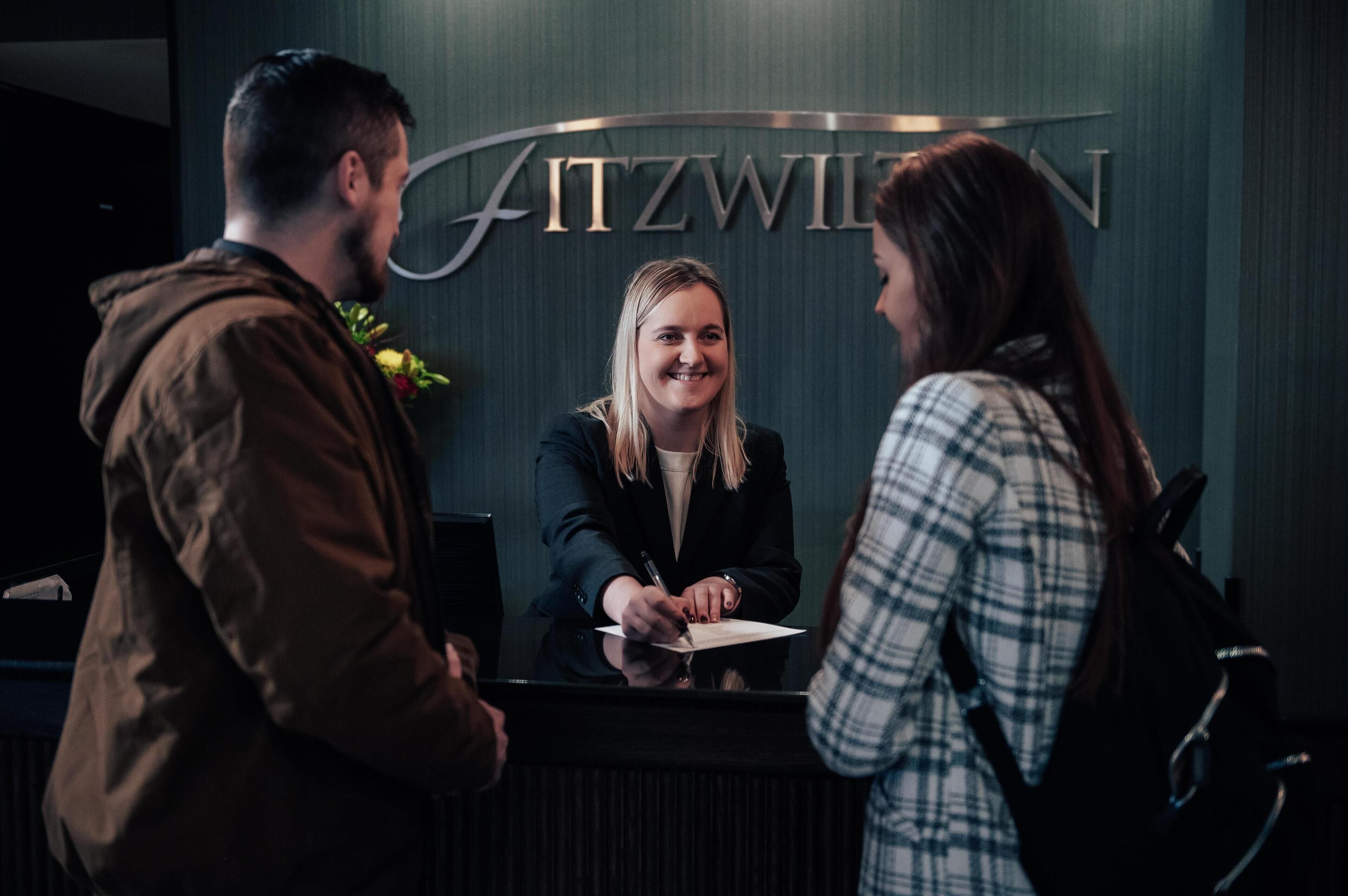 A reception desk with a sign that reads "FITZWIL".