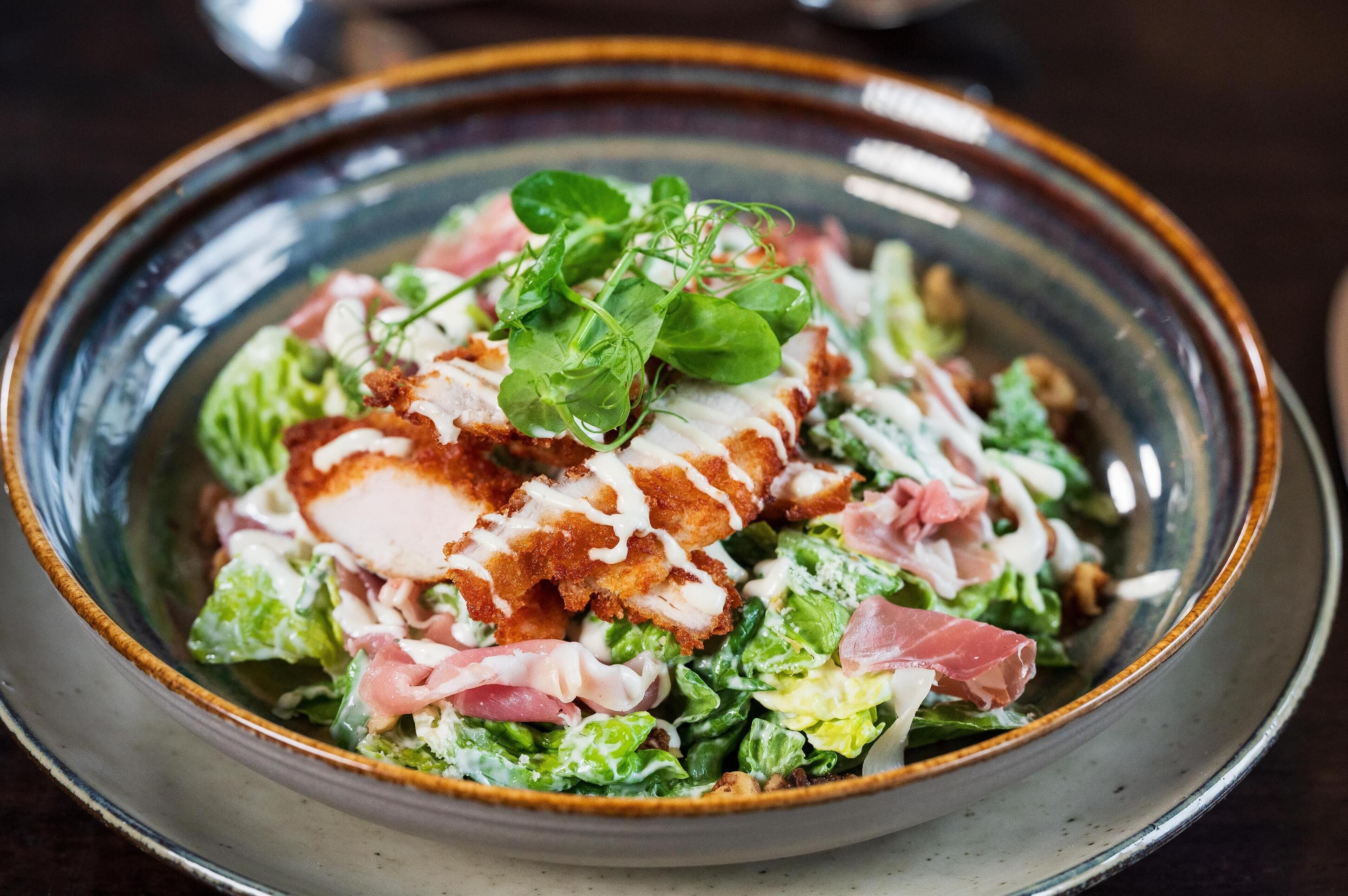 A bowl of salad with various ingredients.