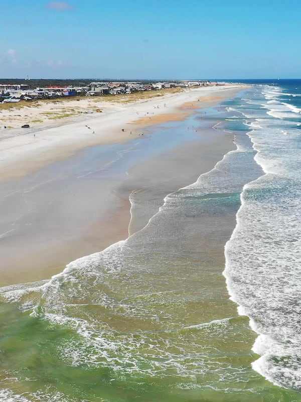 On the beach, white sand, beach umbrellas, beach towels