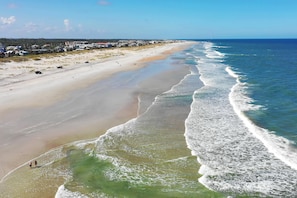 On the beach, white sand, beach umbrellas, beach towels