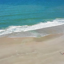 On the beach, white sand, beach umbrellas, beach towels