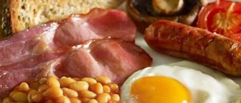 A plate with eggs, beans, bacon, sausages, mushrooms, and toast.