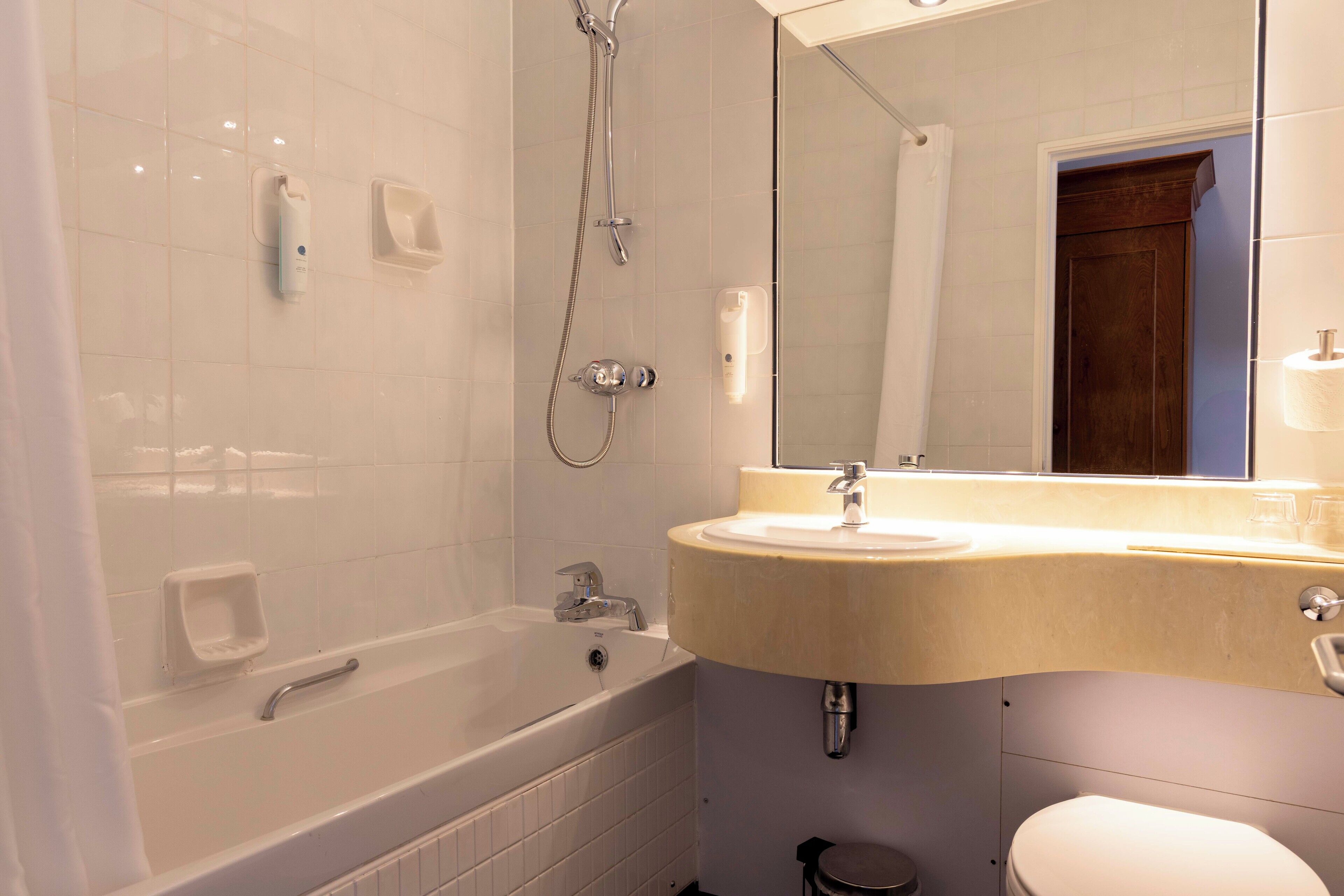 A bathroom with a bathtub, a sink, and a toilet.