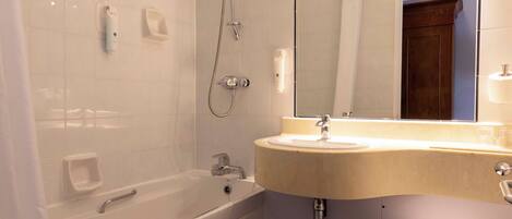 A bathroom with a bathtub, a sink, and a toilet.