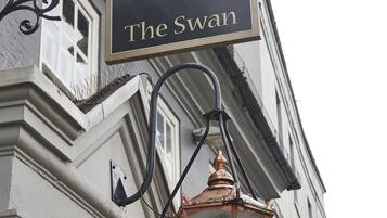 A building with a sign reading "The Swan".
