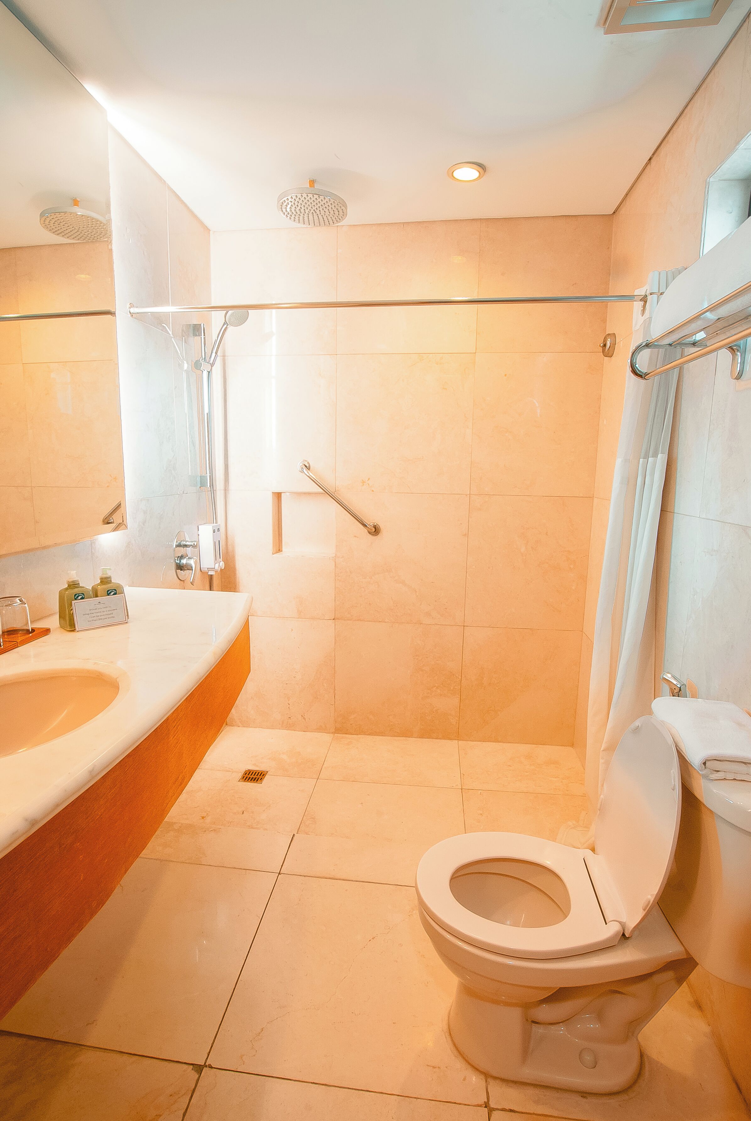 A bathroom with a shower, toilet, and sink.