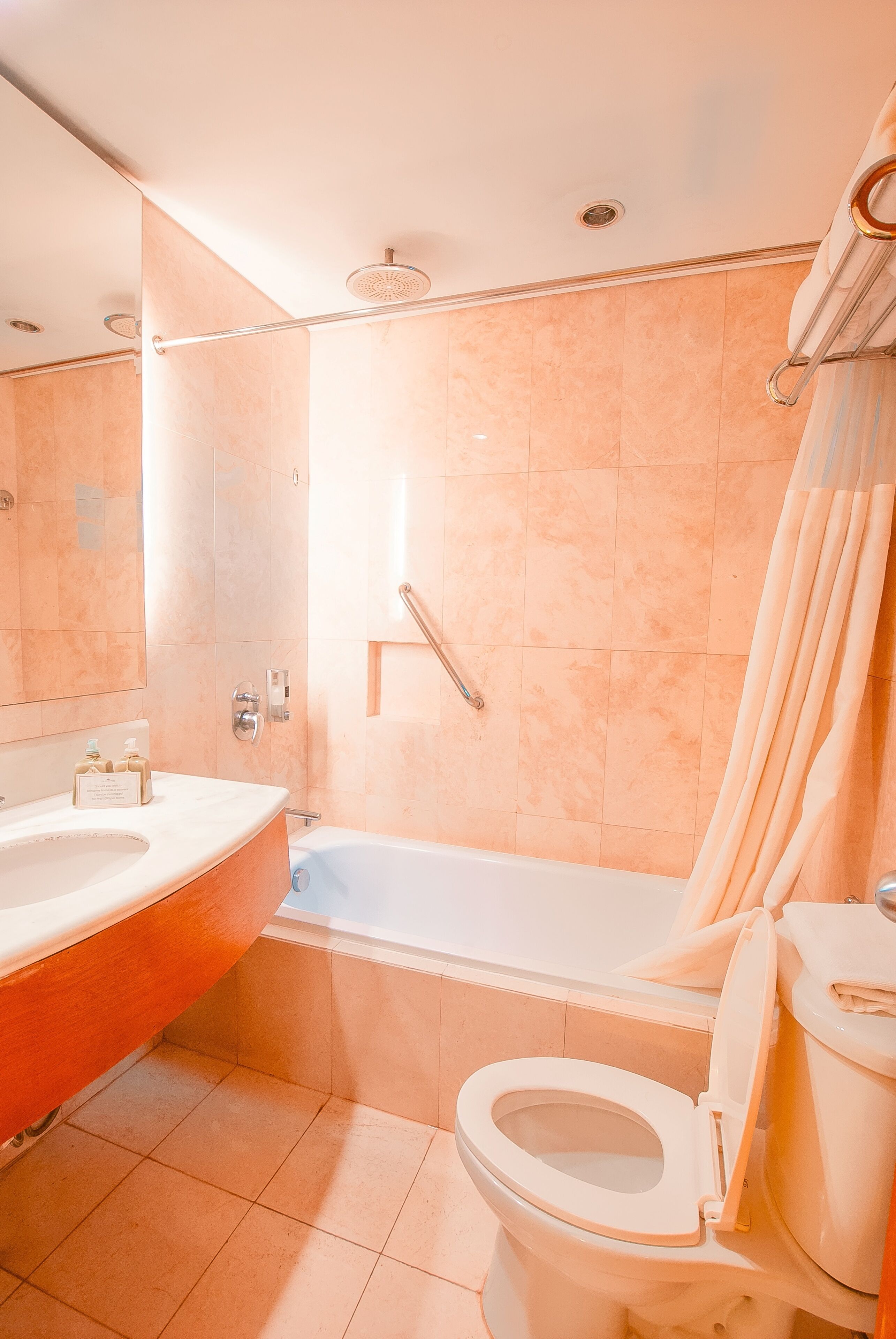 A bathroom with a bathtub, toilet, and sink.