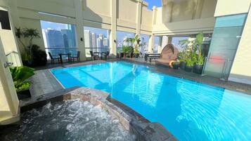 Outdoor pool, open 6:00 AM to 10:00 PM, pool loungers