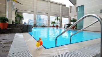Relax by the pool with a view of the city skyline.