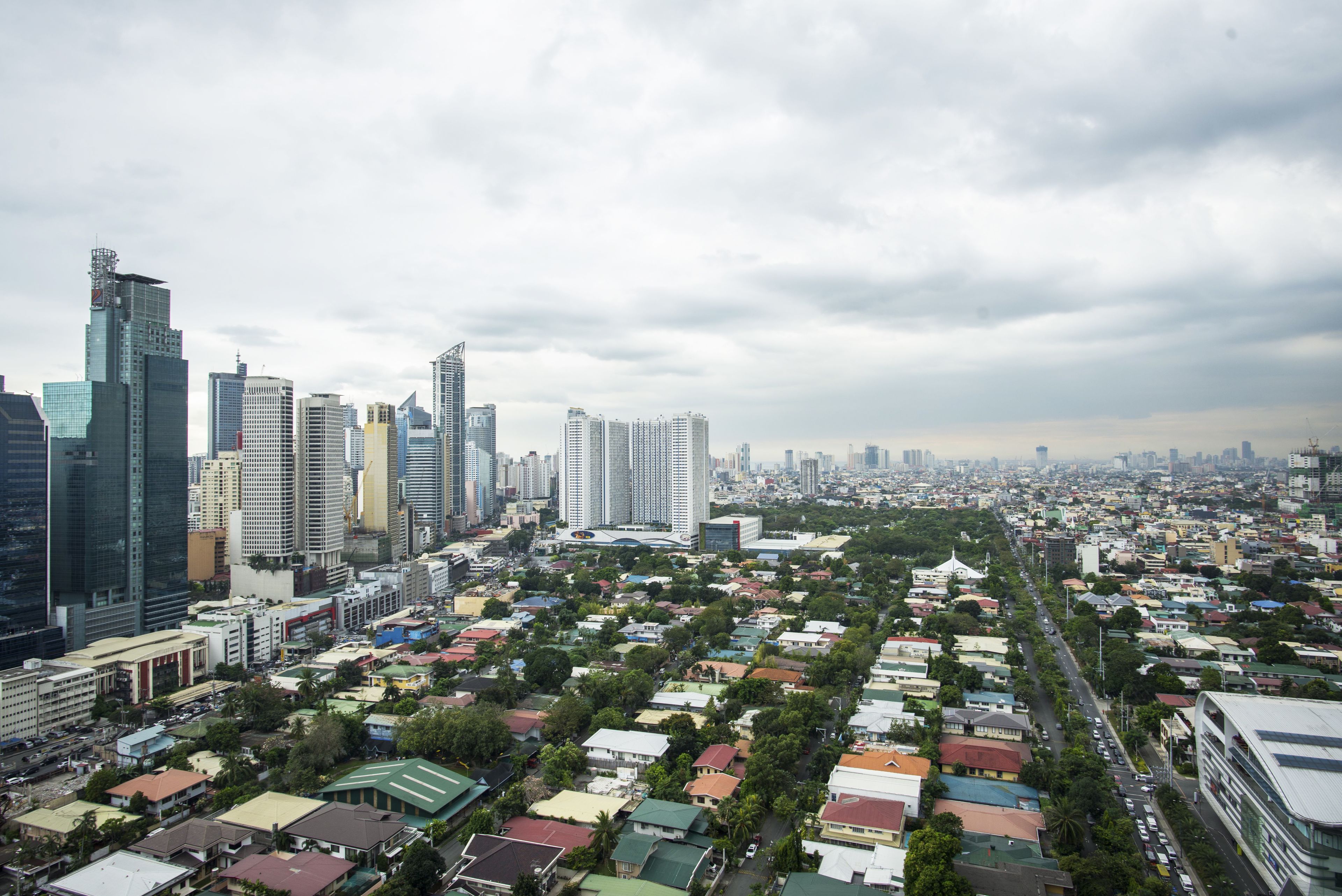 A cityscape with high-rise buildings and a dense residential area.