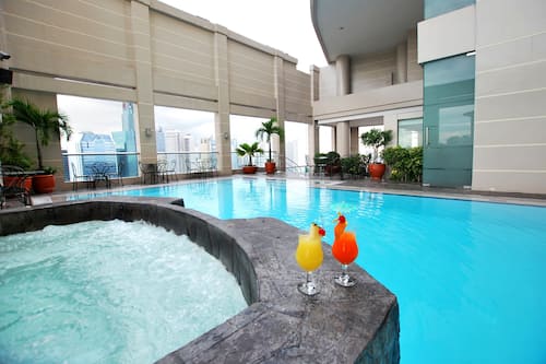 Outdoor pool, open 6:00 AM to 10:00 PM, pool loungers
