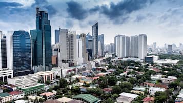 A cityscape with modern high-rise buildings and a mix of residential and commercial structures.