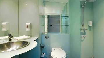 A modern bathroom with a sink, toilet, and shower.