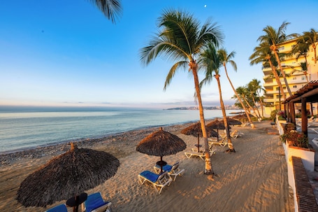 On the beach, beach umbrellas, beach towels. Vista Vallarta All Suites on the Beach