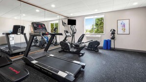 A gym with treadmills, elliptical machines, and exercise bikes.