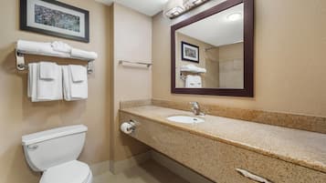 A bathroom with a toilet, sink, and towel rack.