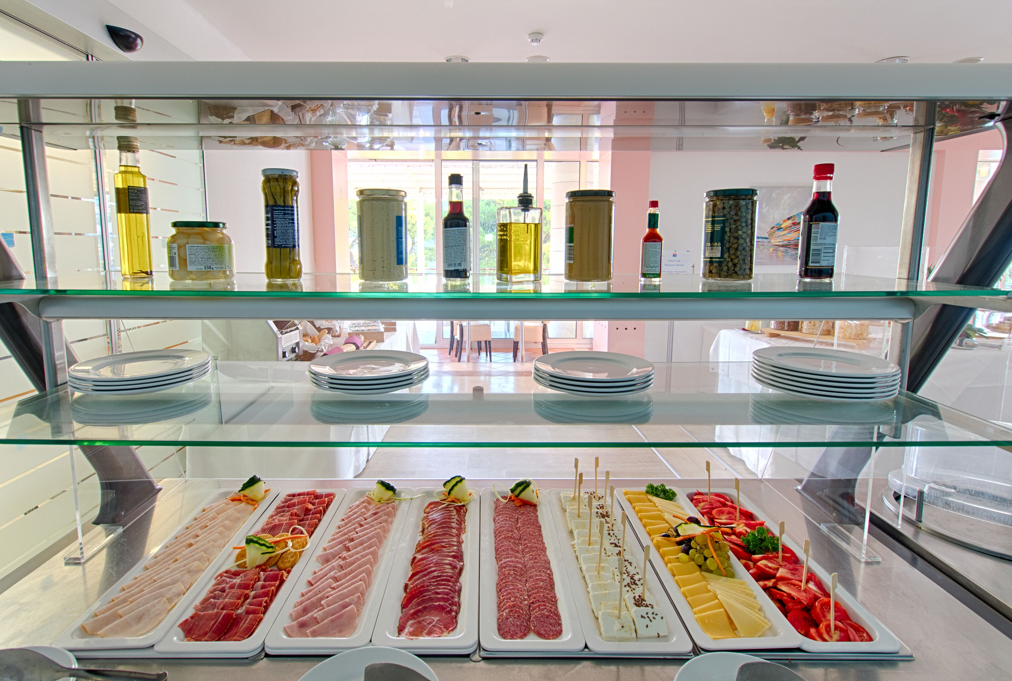 A buffet with various food items and condiments.