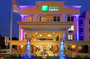 A Holiday Inn Express hotel with a covered entrance, brick facade, and illuminated signage.