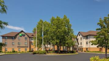 A Holiday Inn Express hotel with a parking lot and surrounding greenery.