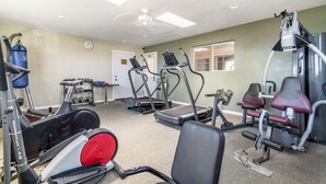 A gym with cardio machines, weight benches, and a punching bag. - Rodeway Inn Barstow Route 66 (Barstow)