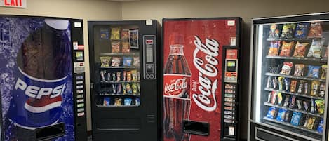 Three vending machines with Pepsi, Coca-Cola, and a variety of snacks.