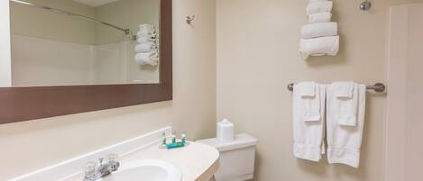 A bathroom with a sink, toilet, and towel rack.