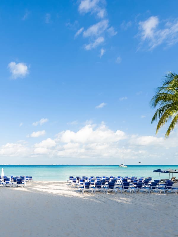 On the beach, white sand, sun loungers, beach umbrellas