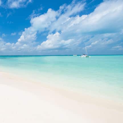 On the beach, white sand, sun loungers, beach umbrellas