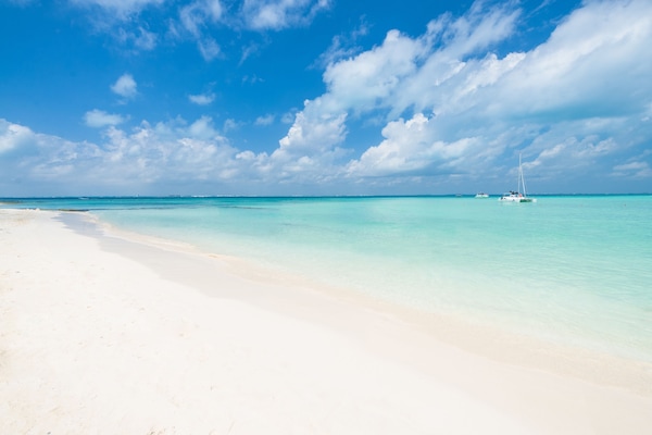 On the beach, white sand, sun-loungers, beach umbrellas