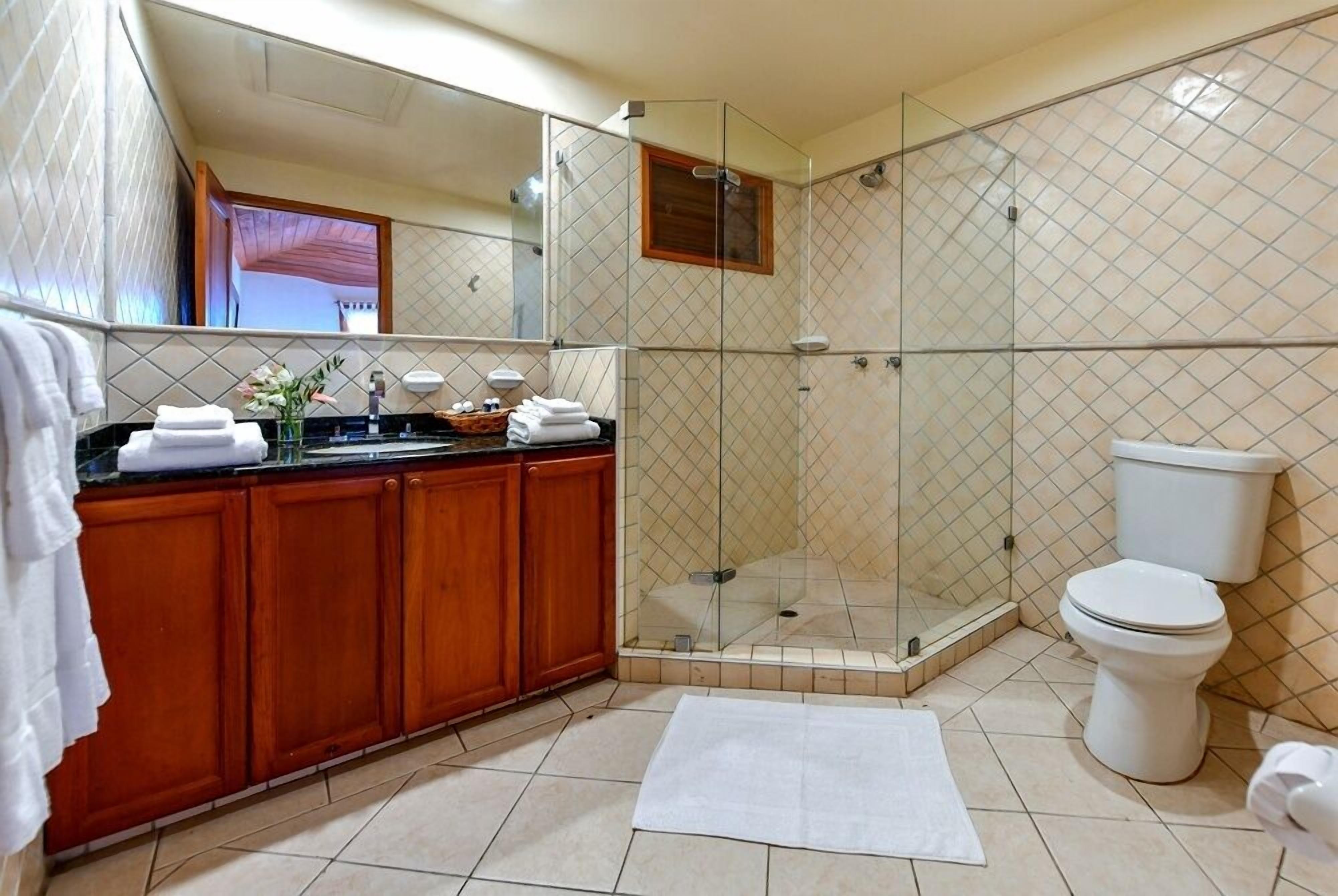 deluxe studio, 1 king bed, balcony, sea view | bathroom | shower, designer toiletries, hair dryer, towels