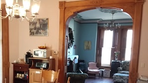 A dining area with a table and chairs, a kitchen area with appliances, and a living room with a sofa and a chair. - Inn Port Lodging (Dayton)