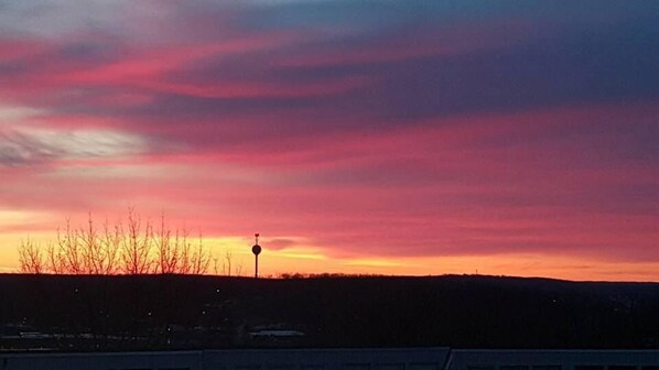 A sunset with a clear sky and a silhouette of a landscape.